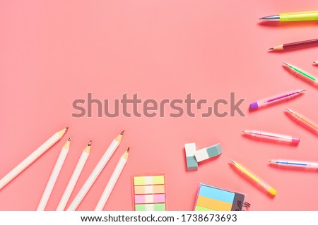 Workplace with stationery accessories on pink countertop. Business or back to school concept. Secretaries workspace. Top view. Flat lay. Copy space