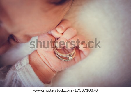 Baby hand. Closeup of newborn baby hand into parents hands. Family concept with the wedding rings in baby hand. Royalty-Free Stock Photo #1738710878