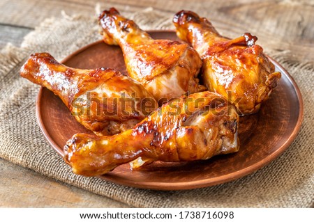 Grilled chicken drumsticks on a plate flat lay Royalty-Free Stock Photo #1738716098