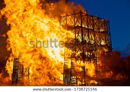 Burning wooden buildings close-up. Raging flames of fire. Firestorm closeup. Building is on fire. Bright inferno flames. Hell fire. Burning constructions background. Intense combustion and heat. Royalty-Free Stock Photo #1738725146