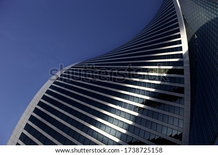 Futuristic part of skyscrapers design on clear blue sky background. Abstract facade design. Glass and metal in modern city architecture. Modern buildings exterior. Construction industry. Abstraction. Royalty-Free Stock Photo #1738725158