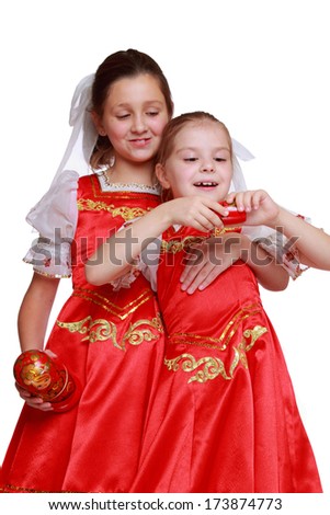 Russian little girls holding traditional matryoshka doll with the little doll inside. 