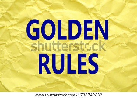 Sheet of color crumpled paper with phrase GOLDEN RULES