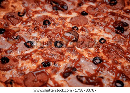 Pizza with mozzarella cheese, salami, tomatoes, pepper, and spices. Italian pizza. Close-up
