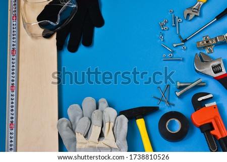 Professional repair tools for decoration and building repair on a blue background. View from above. Place for text