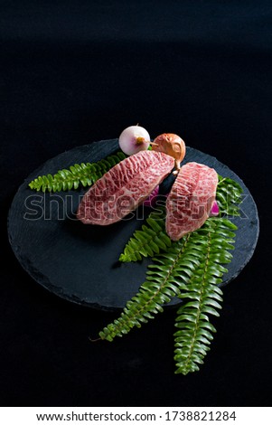 Snowflake beef on a black plate