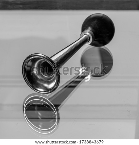 manual bicycle air horn reflecting in glass top