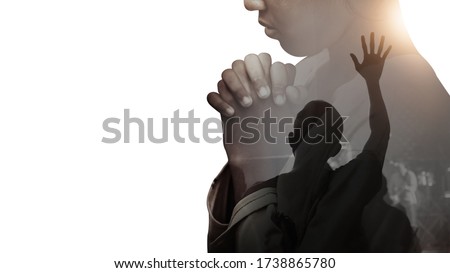 Double exposure of a hand girl praying and worship in the church, Hands folded in prayer concept for faith, spirituality and religion, Hands Raised In Worship background. Royalty-Free Stock Photo #1738865780