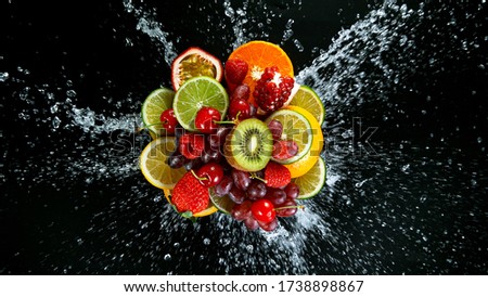 Super Slow Motion Shot of Fresh Fruits with Splashing Water Isolated on Black Background. Royalty-Free Stock Photo #1738898867