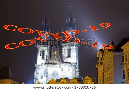 Coronavirus in Prague, Czech Republic. The gothic Church of Mother of God in front of Tyn in Old Town Square. Covid-19 sign. Concept of COVID pandemic and travel in Europe.