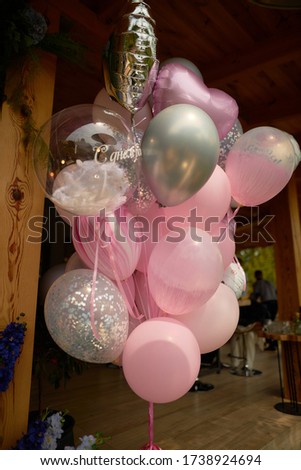 A lot of festive pink balls. Air balloons.
