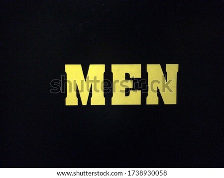 yellow sign men text restroom on black background