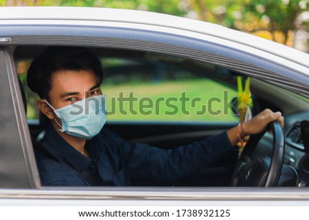 Asian men wear medical masks while driving. Man wearing in the medical protective mask protect from bacteria Corona virus while driving a car. Coronavirus, disease, infection, quarantine, covid-19. Royalty-Free Stock Photo #1738932125