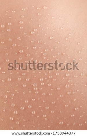 detail of hydrated skin with a lot of drops of water on the surface