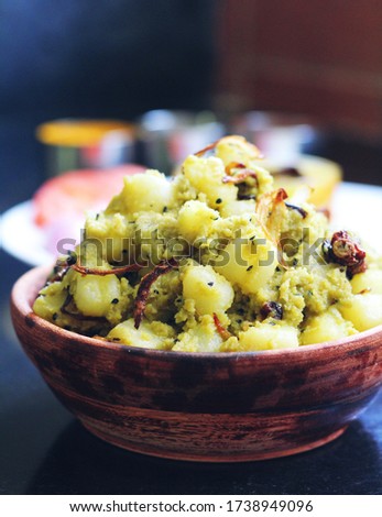 Aloo Posto, A preparation of potatoes in mustard oil with poppy seeds paste.