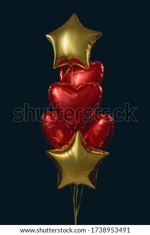 group of 6 air foil balloons, in the form of stars and hearts, red and gold colors, filled with helium. Decoration for birthday, Valentine's Day. isolated on a black background.