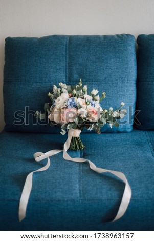 
Bridal bouquet on a blue background, roses, peonies, bare, white, pink flowers, long ribbons