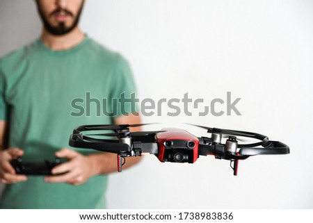 man or boy having fun flying drones inside his house during the COVID confinement