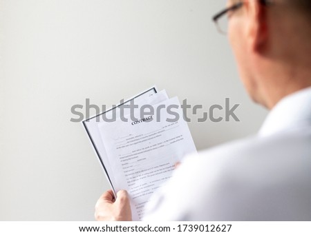 picture of man hands holding contract with text