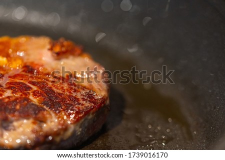 Pictures  of a sliced fresh rump steak with fat on the steak in a pan, which the steak cooks through in high heat