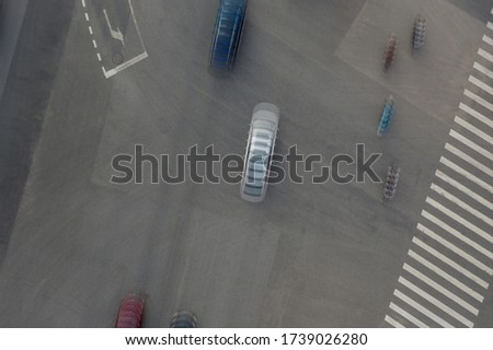 Aerial view of blurred trajectory of moving cars at city street intersection