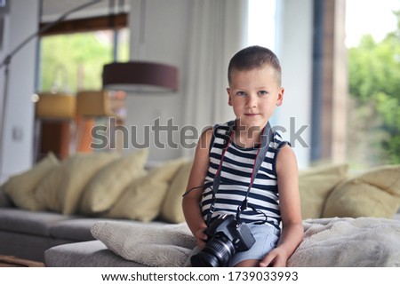 
child with digital camera at home