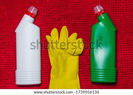 cleaning concept. Cleaning products and yellow gloves are on the red carpet. Photo above