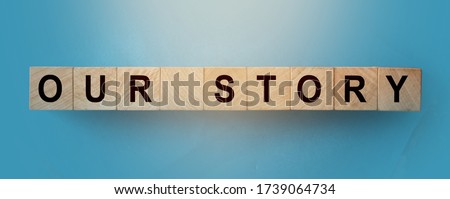 OUR STORY words on wooden cubic building block . Business with history, concept. Royalty-Free Stock Photo #1739064734