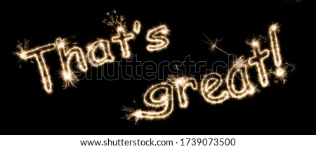 The inscription "That's great!" on a black background with sparklers using a simulated long exposure.