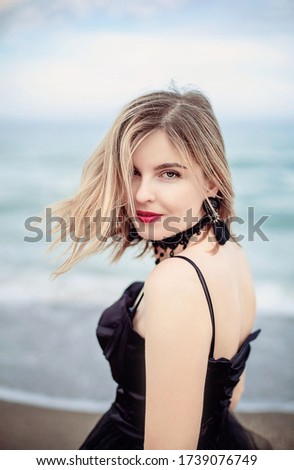 

girl by the sea in a black long dress