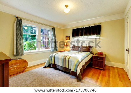 Yellow tones bedroom with soft beige rug and wood furniture