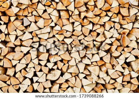 Stacked firewood close-up. Firewood storage close up. Stocks of wooden logs close-up. Chopping wood. Logging in the village. Rustic lifestyle. Woodpile with firewood full frame image. Wooden texture. Royalty-Free Stock Photo #1739088266