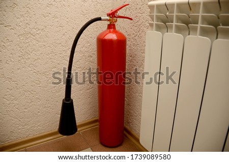 Red fire extinguisher in the office for safety during a fire. Safety concept