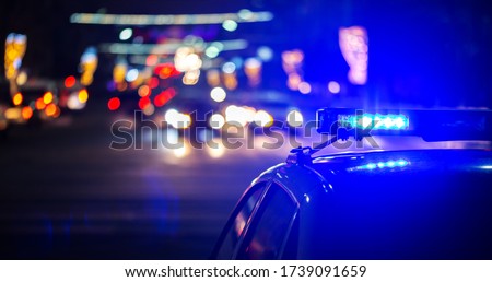 night police car lights in city - close-up with selective focus and bokeh