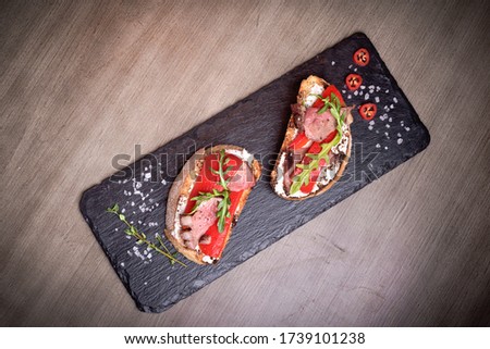 Two brutal sketches of meat and Bulgarian pepper on stone plates. restaurant giving. for the menu of cafe. wooden table