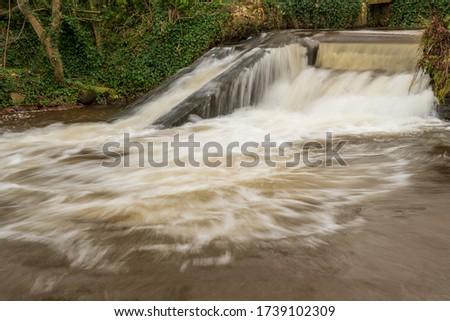 Long exposure of a waterfall on the river Avill in Dunster in Somerset
