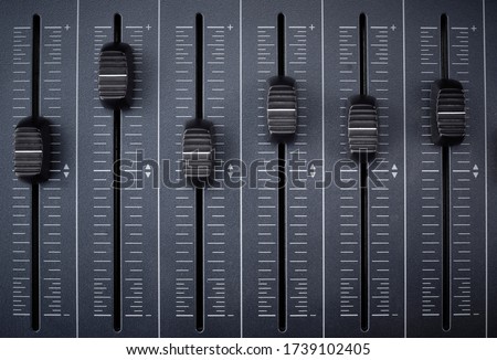 faders of a mixer for audio production and control of equalization and mixing using midi technology Royalty-Free Stock Photo #1739102405