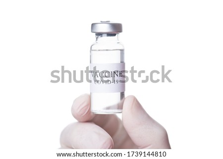 Immunization and treatment concept. Close-up cropped macro photo of doctor holding a vial of COVID-19 vaccine  isolated on white background