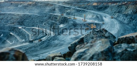 Work of trucks and the excavator in an open pit on gold mining, soft focus Royalty-Free Stock Photo #1739208158