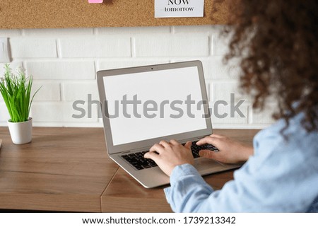 African american young woman student worker elearning working online from home office typing on laptop computer mock up white blank screen. Web education concept. Close up over shoulder back view. Royalty-Free Stock Photo #1739213342