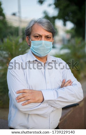 Portrait of mature man with mask for protection from corona virus and pollution.