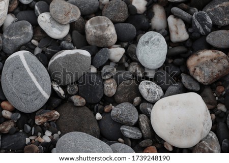 Beautiful round-shaped stones and rocks on the beach.