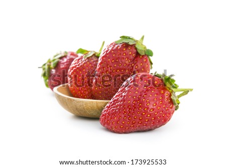 Strawberry on wood spoon isolated on white background.