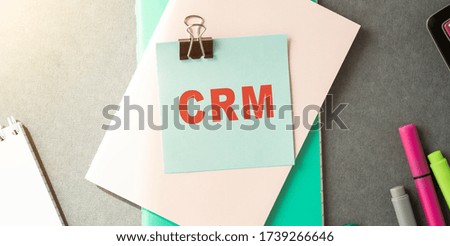 Businessman putting a card with text CRM