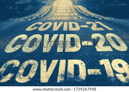 Deserted highway with the text COVID-19, COVID-20, COVID-21 and so on. The concept of new world pandemics. Blue background Royalty-Free Stock Photo #1739267948