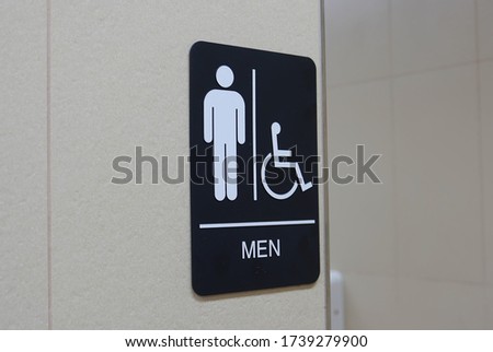 Motion of man and disable washroom logo on wall