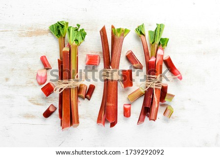 Fresh rhubarb on a white wooden background. Top view. Free copy space.