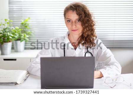 portrait of female doctor working on laptop telemedicine concept Royalty-Free Stock Photo #1739327441