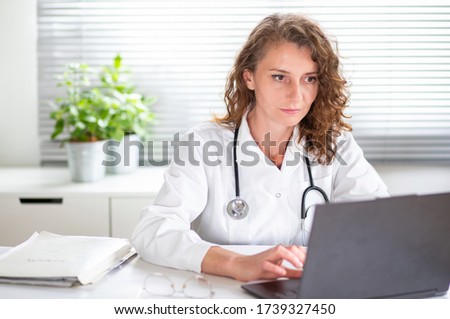 portrait of female doctor working on laptop telemedicine concept Royalty-Free Stock Photo #1739327450