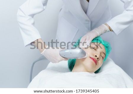 Woman getting Hifu spa treatment, girl receiving  ultra former massage face. Anti aging treatment and plastic surgery concept. Royalty-Free Stock Photo #1739345405